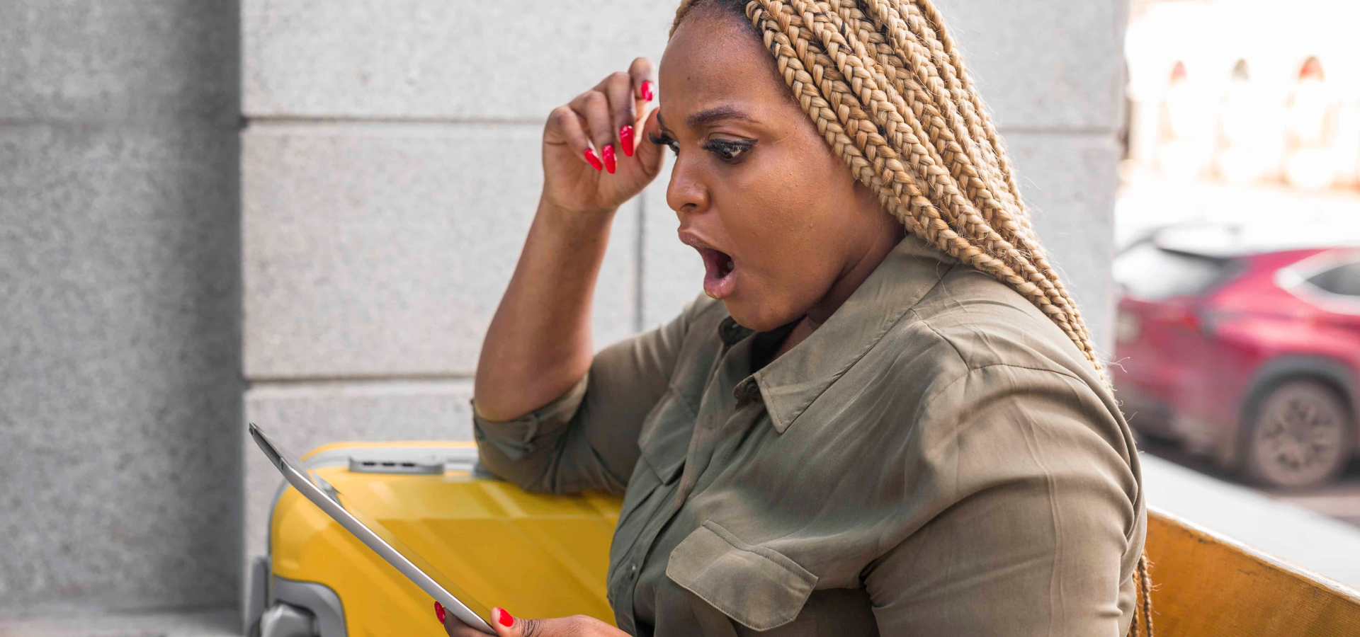 Woman with tablet reacting to an unexpected expense
